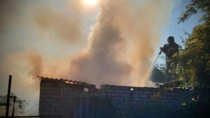 пожежа, рятувальник ліквідвує пожежу, горить будівля